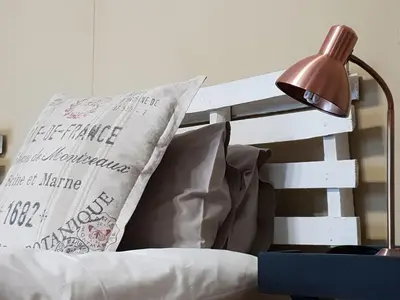 a bed with a lamp and pillows on it at Rand Self-catering Accommodation in Carolina