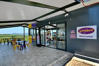 a restaurant with tables and chairs in a building at SleepOver KMIA in White River