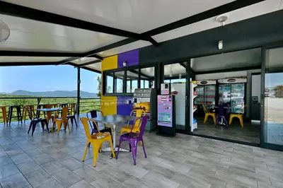 a restaurant with tables and chairs and a table at SleepOver KMIA in White River