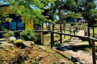 a fence in front of a yellow building with a gate at SleepOver KMIA in White River