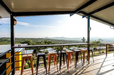 a view from the balcony of a house with stools at SleepOver KMIA in White River