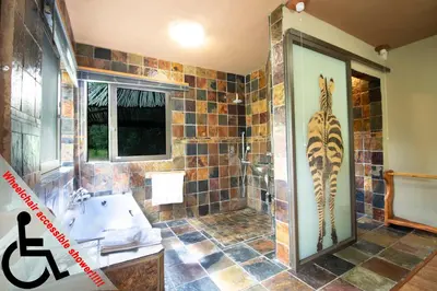 a bathroom with a tub and a sink at Adventure Bush Villa in Marloth Park