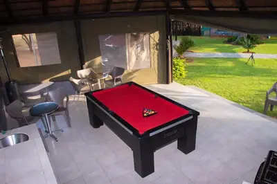 a ping pong table sitting on a patio at Sasavona Game Lodge in Warmbaths