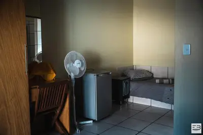 a room with a fan in a room with a bed at Geluksfontein Private Game Farm in Cullinan