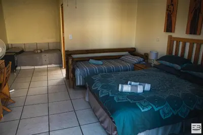a room with two beds in a room at Geluksfontein Private Game Farm in Cullinan