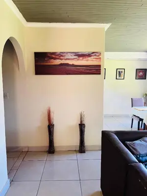 a living room with two vases on the wall at Angelmalatji guesthouse in Graskop