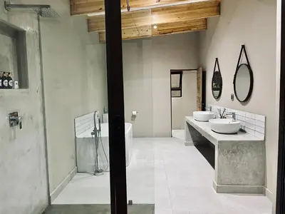 a bathroom with two sinks and a shower at Bushbaby Valley Lodge in Hazyview