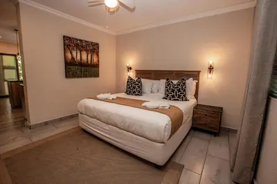 a bedroom with a large bed in a room at Bushbaby Valley Lodge in Hazyview