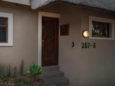 a front door of a house with a sign on it at Mabalingwe Elephant Lodge 267-7 & 267-8 in Mabula