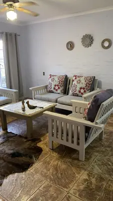a living room with a couch and a table at Die Kothuis in Malelane