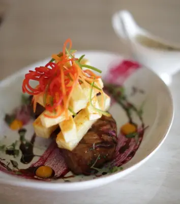 a plate of food with vegetables on a table at Palala Boutique Game Lodge and Spa in Tom Burke