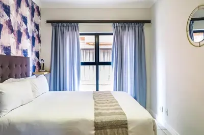 a bedroom with a large bed and a window at Insaka 3 The Blyde Lagoon Experience in Pretoria