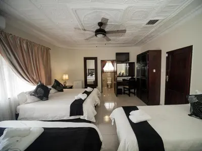a bedroom with two beds and a ceiling at Dunwoodie Travel Lodge in Pretoria