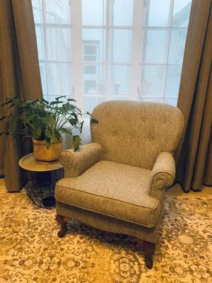 a chair sitting in a room with a window at Battiss Guest House in Pretoria