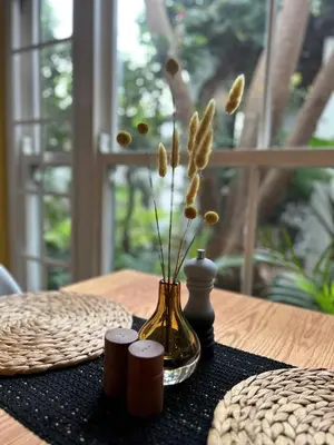 a vase with flowers in it sitting on a table at Battiss Guest House in Pretoria