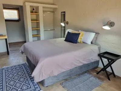 a bedroom with a large bed in a room at Kolope Lodge in Alldays