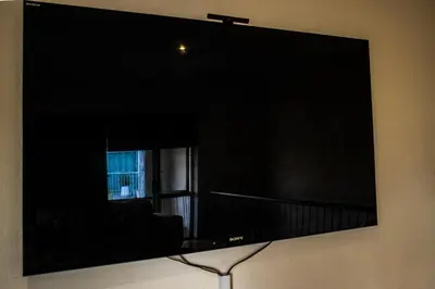 a large flat screen tv on a wall at Sunninghill Luxury Spacious Executive Penthouse in Sandton