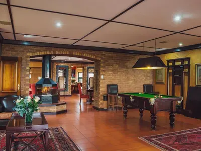 a living room with a pool table in it at Cussonia Country Home in Tierpoort
