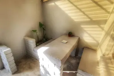 a small room with a wooden table in a room at Sheilas Self-Catering Overnight Accommodation in Polokwane