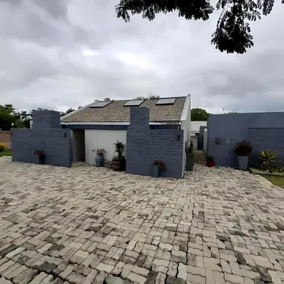 a house with a brick driveway in front of it at Sheilas Self-Catering Overnight Accommodation in Polokwane