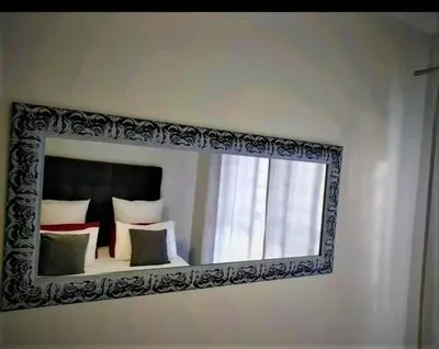 a mirror on a wall in a bedroom at The Blyde Crystal Lagoon in Pretoria