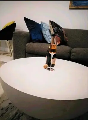 a bottle of wine on top of a white coffee table at The Blyde Crystal Lagoon in Pretoria