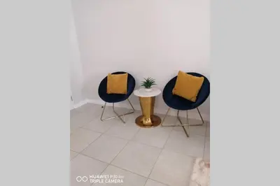 a room with two chairs and a table with a plant at The Blyde Crystal Lagoon in Pretoria