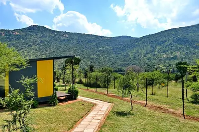 a small house with a yellow door in a field at SleepOver Moria in Moria