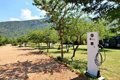 a power meter next to a tree in a field at SleepOver Moria in Moria