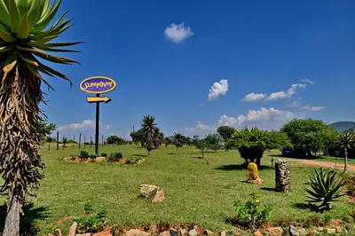 a sign in the middle of a grass field at SleepOver Moria in Moria