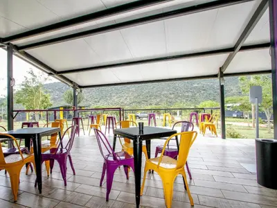 a group of tables and chairs on a patio at SleepOver Moria in Moria
