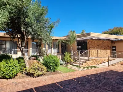 a house with a tree in front of it at Glen Marion Guest House in Pretoria