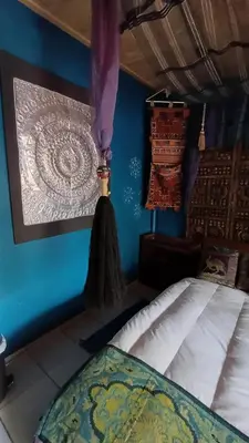 a bedroom with a bed and a blue wall at Wooden Creek Estate in Kempton Park