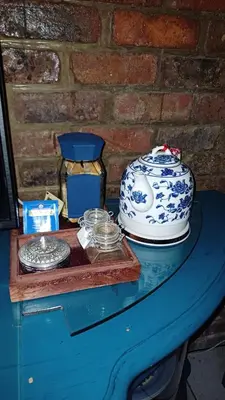 a table with a blue and white pot on it at Wooden Creek Estate in Kempton Park