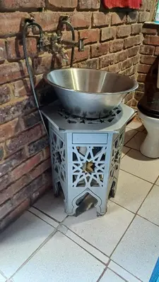 a metal sink on a stand next to a brick wall at Wooden Creek Estate in Kempton Park