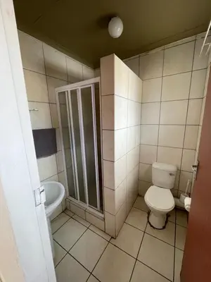 a bathroom with a toilet and a shower at La Fiance Village in Polokwane