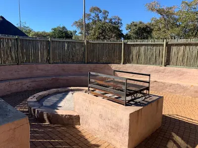 a bench sitting on a concrete slab in front of a fence at Moletani Game Ranch in Kareefontein