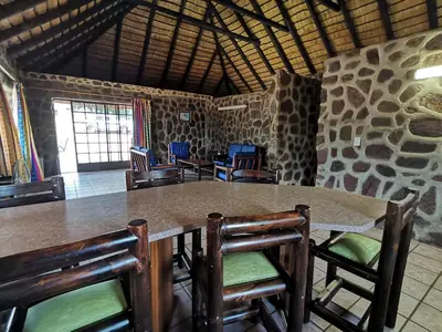a dining room with a large table and chairs at Moletani Game Ranch in Kareefontein