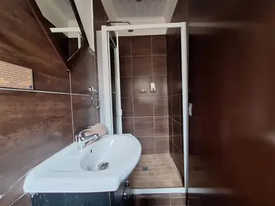 a bathroom with a sink and a shower at Kusile Guest House in Burgersfort