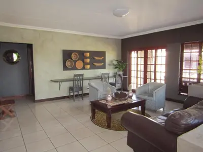 a living room with a couch and a table at Kusile Guest House in Burgersfort