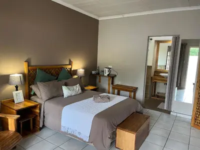 a bedroom with a large bed in a room at Euforia Guesthouse in Middelburg