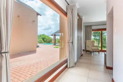 a hallway of a house with a view of a patio at Waterberg House at Zebula 8 adults and 4 kids in Mabula