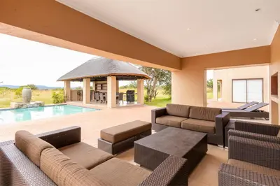 a living room with a pool and a gazebo at Waterberg House at Zebula 8 adults and 4 kids in Mabula