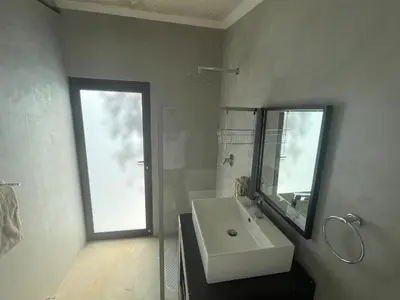 a white bathroom with a sink and a mirror at Newburg Lodge & Luxury Bush Tents, Elements Private Golf Reserve in Moheme
