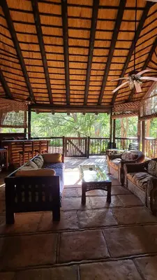 a large room with couches and a table on a patio at Greenfire Hazyview Lodge in Hazyview