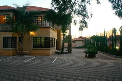 a house with a brick driveway in front of it at Eco Park Lodge in Centurion