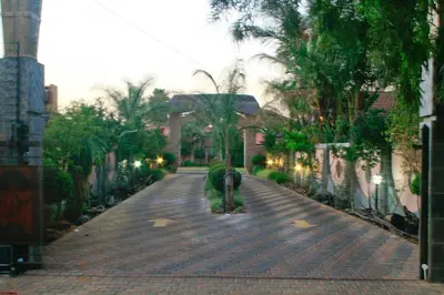 a person is standing on a brick road at Eco Park Lodge in Centurion