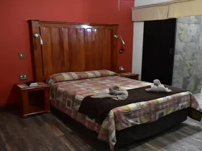 a bedroom with a bed with two stuffed animals on it at Golden Pillow Guest House in Polokwane
