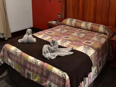 two stuffed animals are sitting on top of a bed at Golden Pillow Guest House in Polokwane