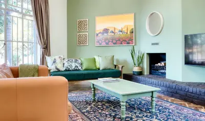 a living room with a couch and a coffee table at The BeeKeeper's Inn in Louis Trichardt